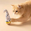 A fluffy orange cat is interacting with a white and blue patterned feather wobble ball toy.