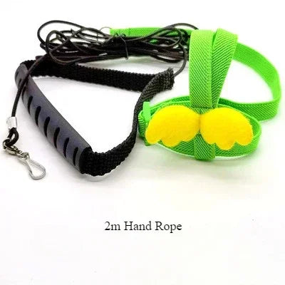 A green and yellow adjustable bird training harness and leash set with a black strap and cord.