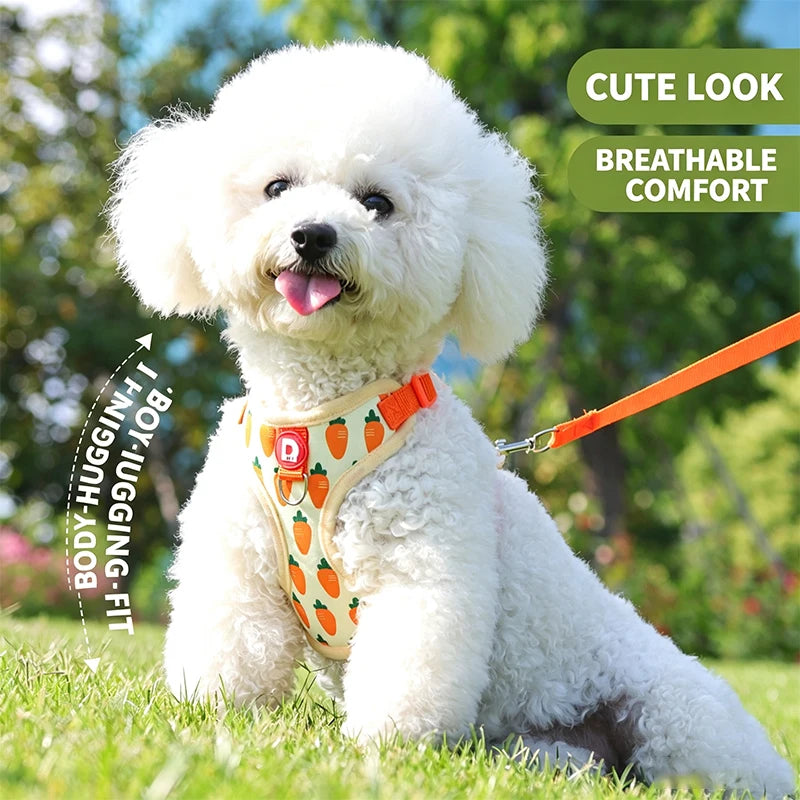 A fluffy white dog wearing an orange harness is lying on green grass.