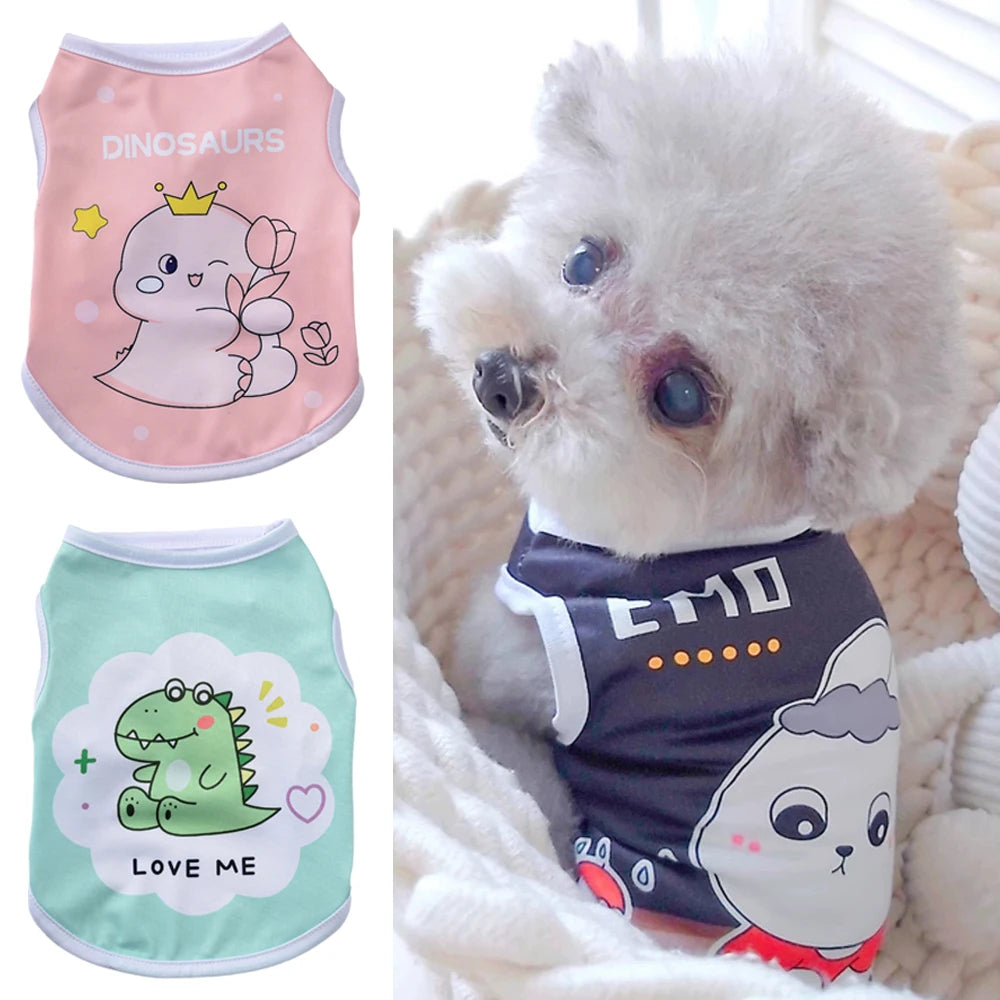 A fluffy white dog is wearing a gray and white printed vest shirt with dinosaur and cloud designs.