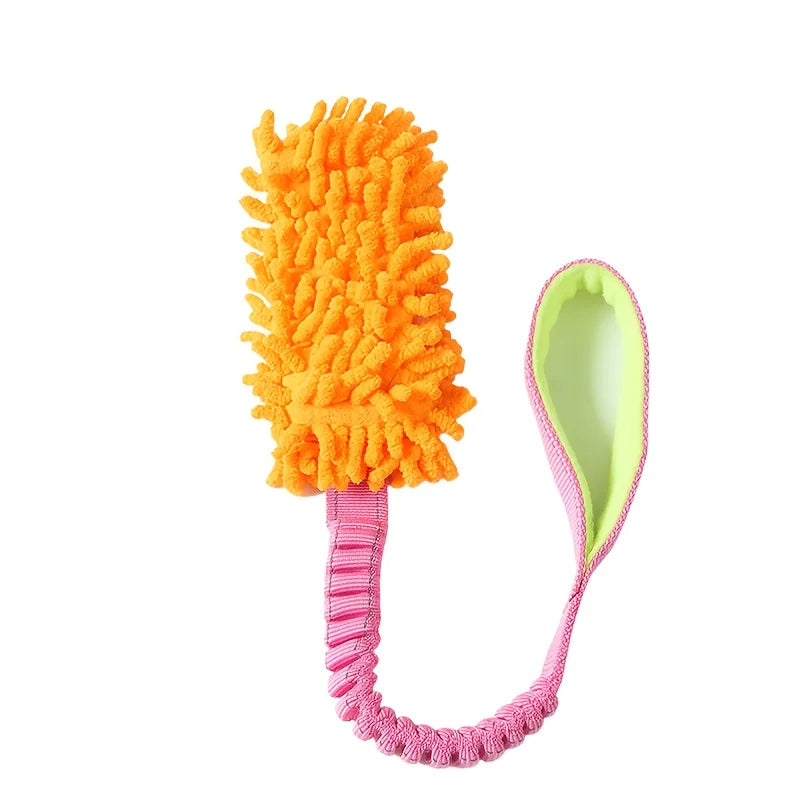 An orange plush pull rope toy with a green scoop attached.