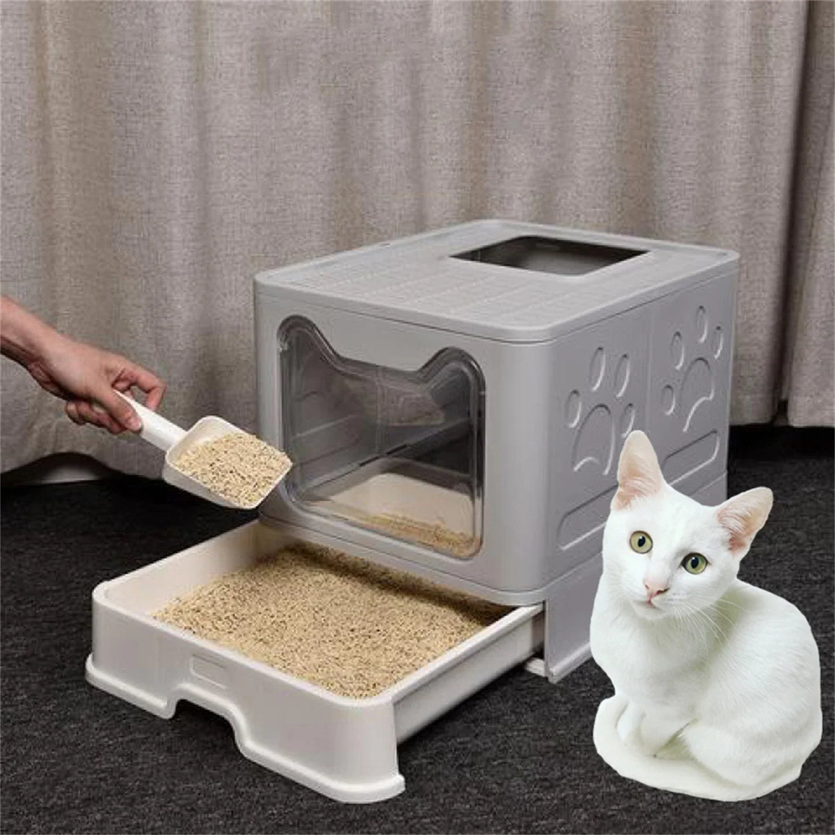 A white foldable cat litter box is shown with a cat sitting next to it on a dark surface.