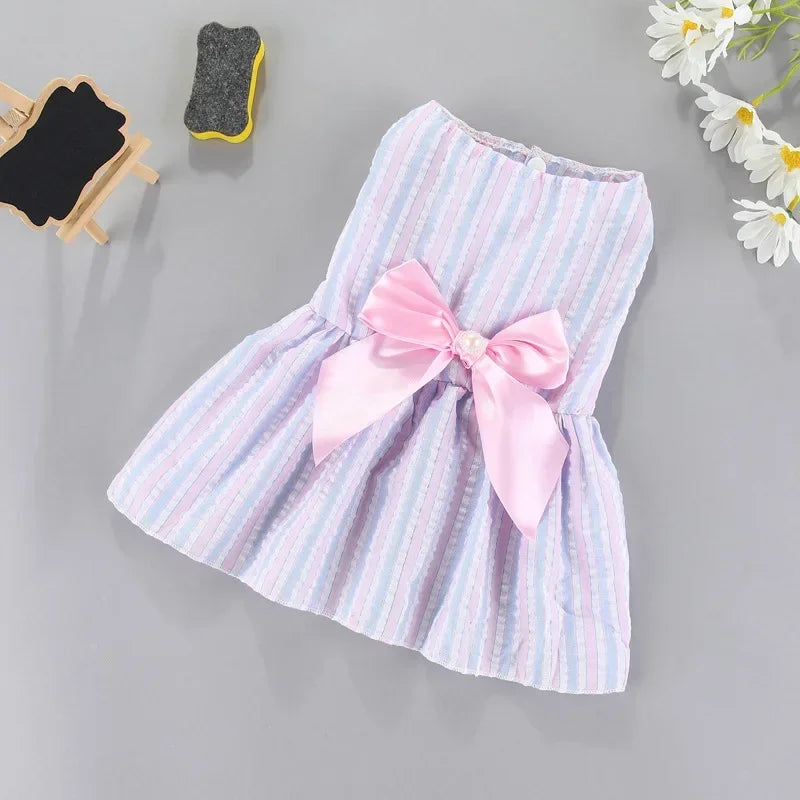 A pink and white striped summer bow dress for a small pet, featuring a large pink satin bow.