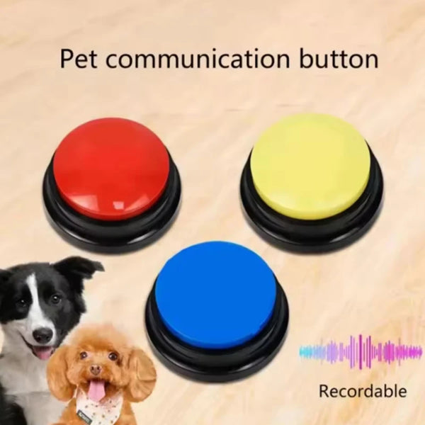 Three colored pet communication buttons, red, yellow, and blue, are shown on a wooden surface.