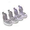 A pack of four purple and gray breathable anti-slip dog walking shoes for pets.