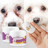 A hand holds a white package of Tear Stain Wipes for pets with a close-up of a dog's face.