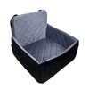 A dark gray and black plush dog car seat with a quilted fabric cushion.