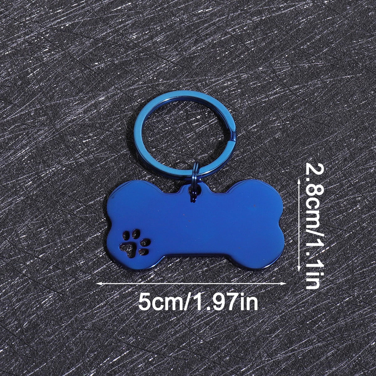A bright blue bone-shaped dog ID tag with a circular keyring, shown against a dark gray background.