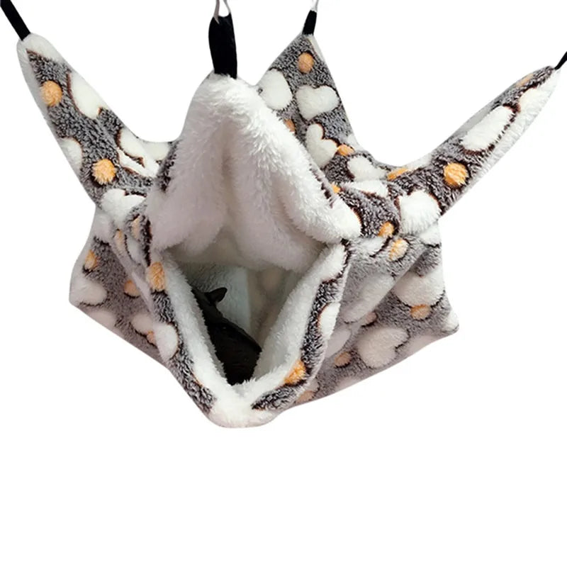A cozy fleece double layer hammock bed for hamsters with a gray and white patterned exterior and a white interior.