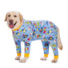 A golden retriever wearing a blue cartoon animal print jumpsuit with yellow trim.