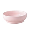 A pink ceramic cat and dog bowl with a stand.