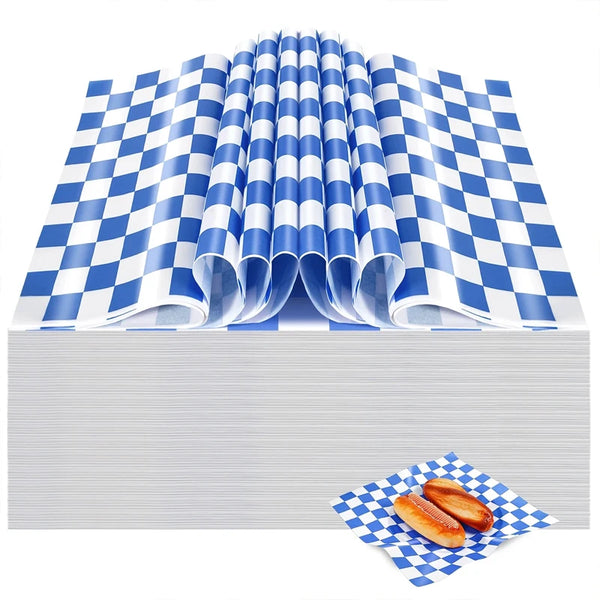 Rolls of blue and white checkered oil-proof sandwich wrapping paper stacked on a surface with a few pieces displayed.