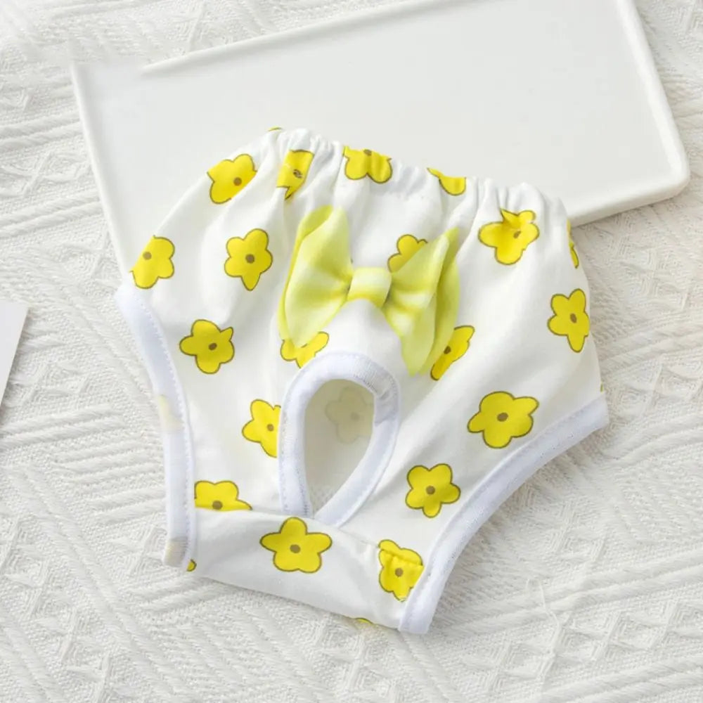 White reusable dog physiological pants with yellow floral print and a light yellow bow