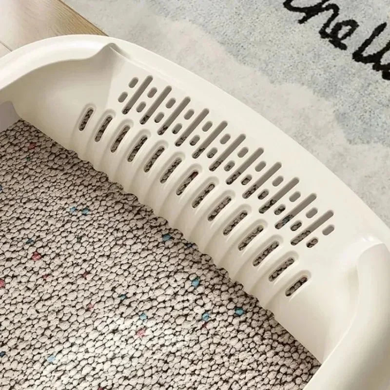 A white high-sided cat litter box with anti-splash design is shown angled over a patterned rug.