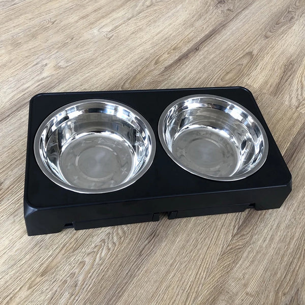 A black tray holding two stainless steel bowls for an adjustable dog feeder.