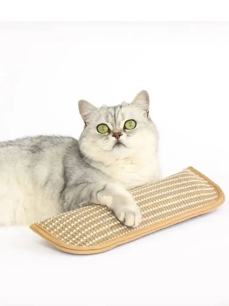 A fluffy gray and white cat is resting on a beige, textured cat scratcher mat.