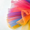 Colorful tulle tutu dress for a small dog featuring shades of pink, purple, blue, and orange.