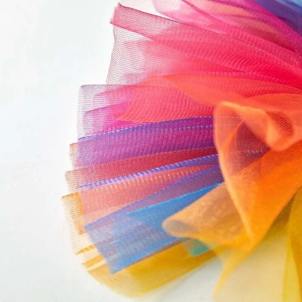Colorful tulle tutu dress for a small dog featuring shades of pink, purple, blue, and orange.