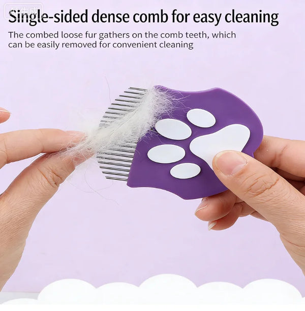 A purple single-sided dense comb with white teeth is being held by a hand, showing the loose fur gathering on the comb.