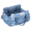 A light blue durable pet car seat with safety straps shown from above.
