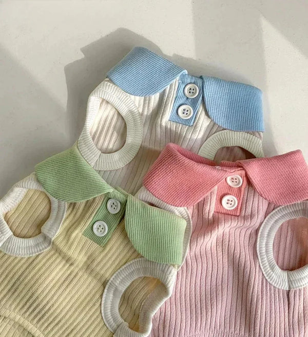 A knitted dog t-shirt with a layered collar featuring light blue, white, and pink accents.