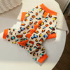 A cozy fleece dog hoodie with animal ears featuring a leopard print and orange trim.