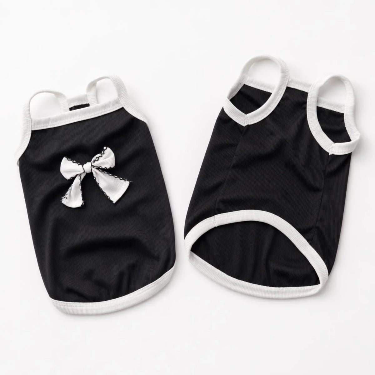 Black pet vest with white trim and a decorative bow knot for small dogs and cats
