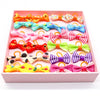A pink tray filled with colorful pet hair bows in various colors like orange, blue, pink, and yellow.