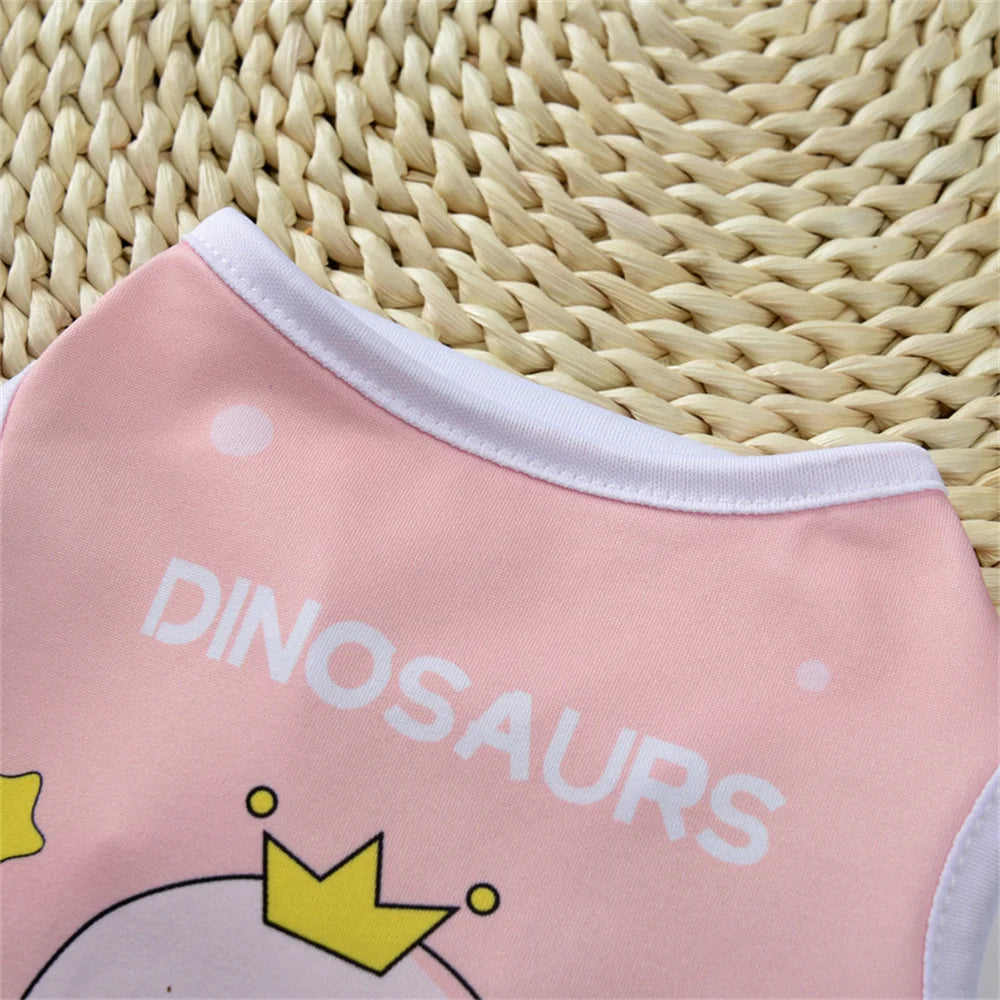Pink sleeveless vest for pets featuring a dinosaur design on a woven natural background.