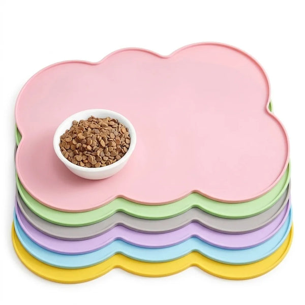 A stack of pink, green, and purple non-slip pet mats with a bowl of kibble on top