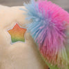 A close-up of a rainbow unicorn plush toy featuring soft, multi-colored fluffy ears.