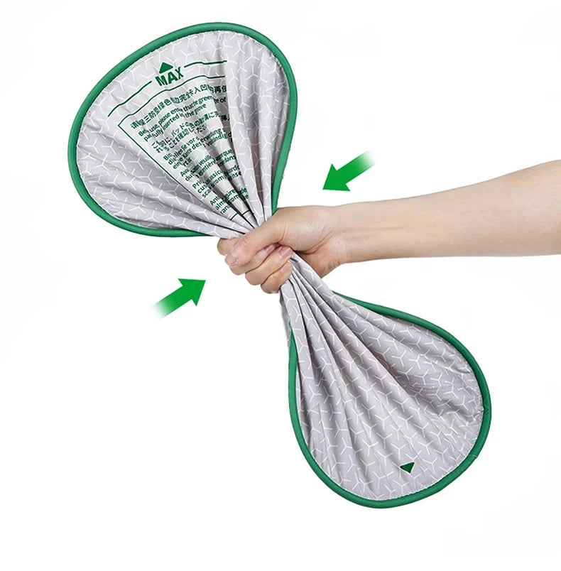 A hand is holding a replacement litter mat for a smart cat toilet, showing the fabric and green trim.