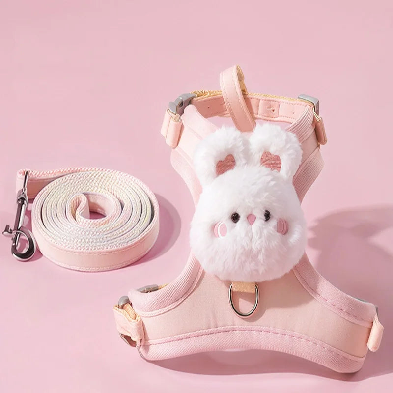 A pink rabbit-themed walking harness and leash set with a white fluffy rabbit charm.