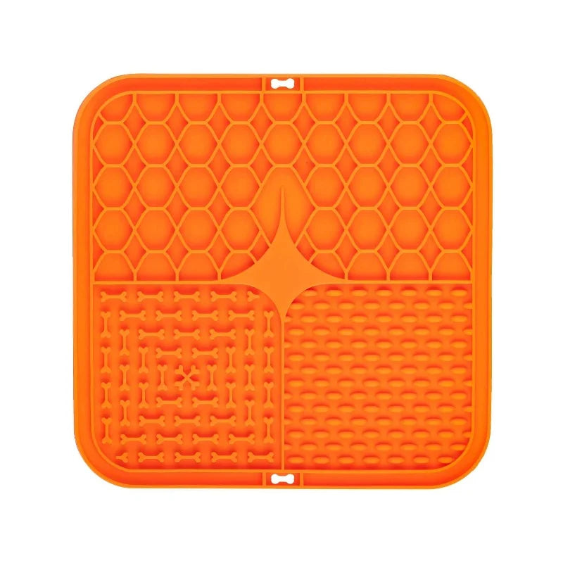 Orange silicone lick mat for dog bathing and slow food training with textured surfaces