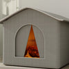 A gray insulated box pet bed with a triangular window showing a dog's head, demonstrating temperature measurement.