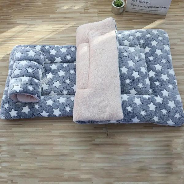 A gray and white star-patterned pet blanket with a pink fleece insert for dogs and cats.
