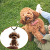 A small, fluffy brown dog is being held outdoors while a transparent pet hair memorial keychain of the same dog is shown in a