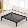 A black portable folding pet bed mesh surface displayed on a white carpet with size options listed nearby.