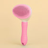 A pink one-button pet hair removal brush for cats and dogs shown against a light background.