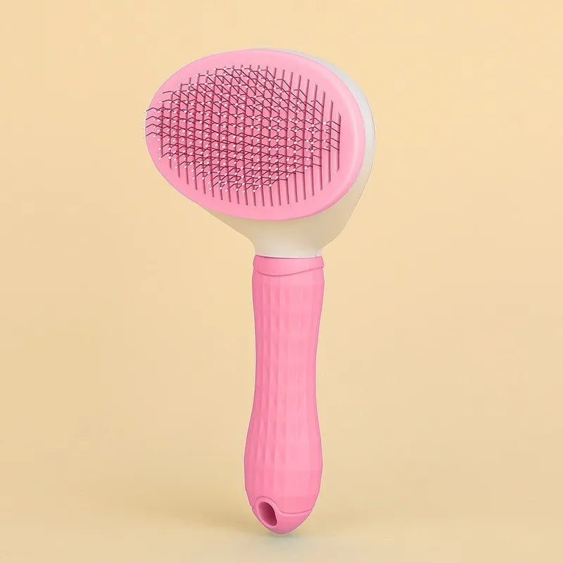 A pink one-button pet hair removal brush for cats and dogs shown against a light background.