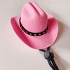 A pink felt cowboy hat with a black studded band, shown against a white background.
