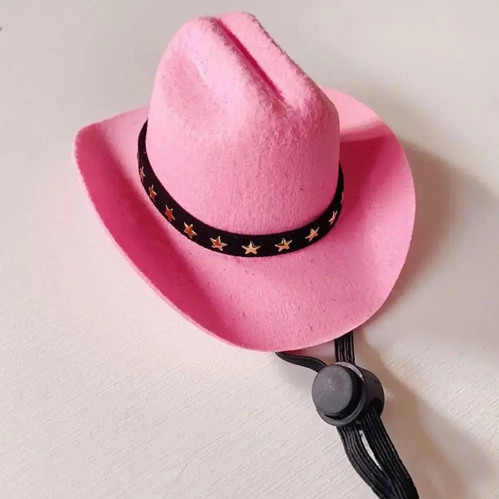 A pink felt cowboy hat with a black studded band, shown against a white background.