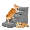 An orange and white dog is stepping onto a gray foam pet stairs ramp.