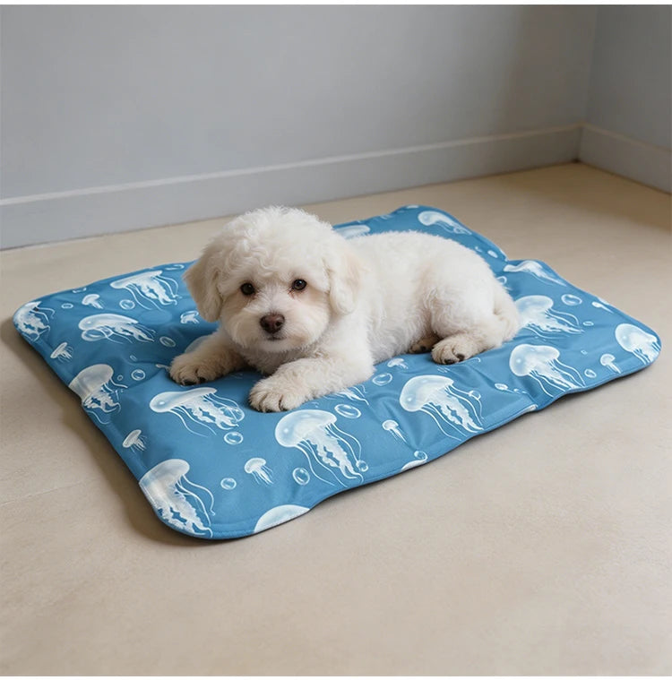 A fluffy white puppy is lying on a blue pet mat decorated with white jellyfish patterns.