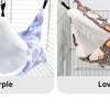 Two plush pet hammocks, one purple and one coffee-colored, displayed against a wire background.