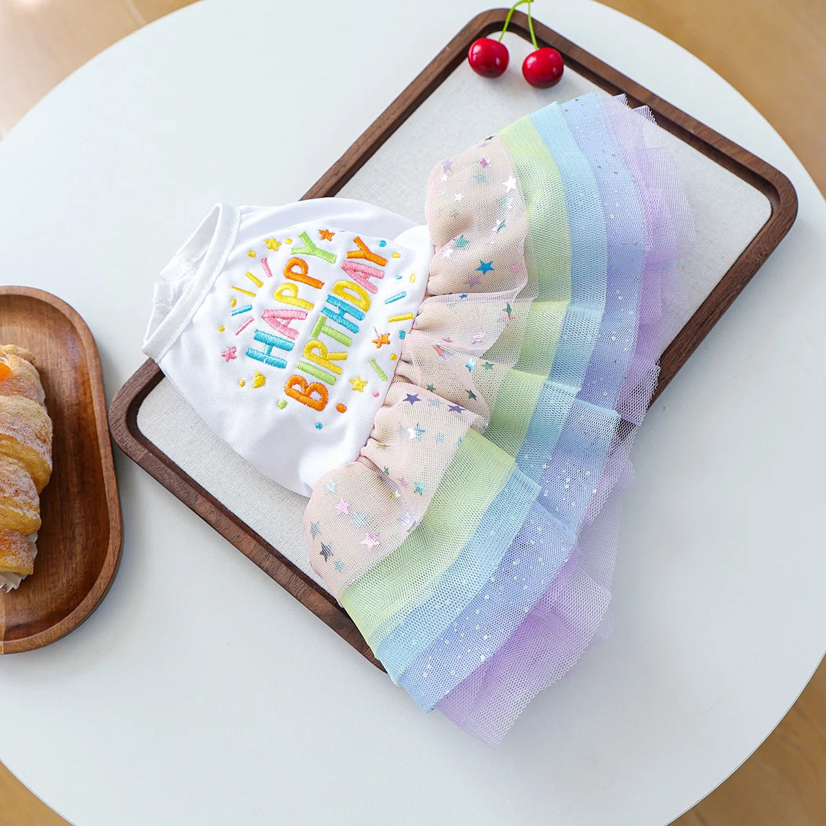 Elegant birthday suit for dogs featuring white tulle with colorful pastel stripes and stars
