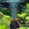 Aquarium volcano decoration featuring a stone structure with bubbling water and aquatic plants.