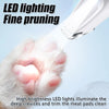 A close-up of a pet paw being illuminated by a bright LED light during fine pruning.