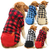 A collection of reversible plaid winter pet jackets for dogs in red, black, and yellow patterns.