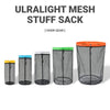 A row of five ultralight mesh stuff sacks in various colors, including black, blue, and orange.